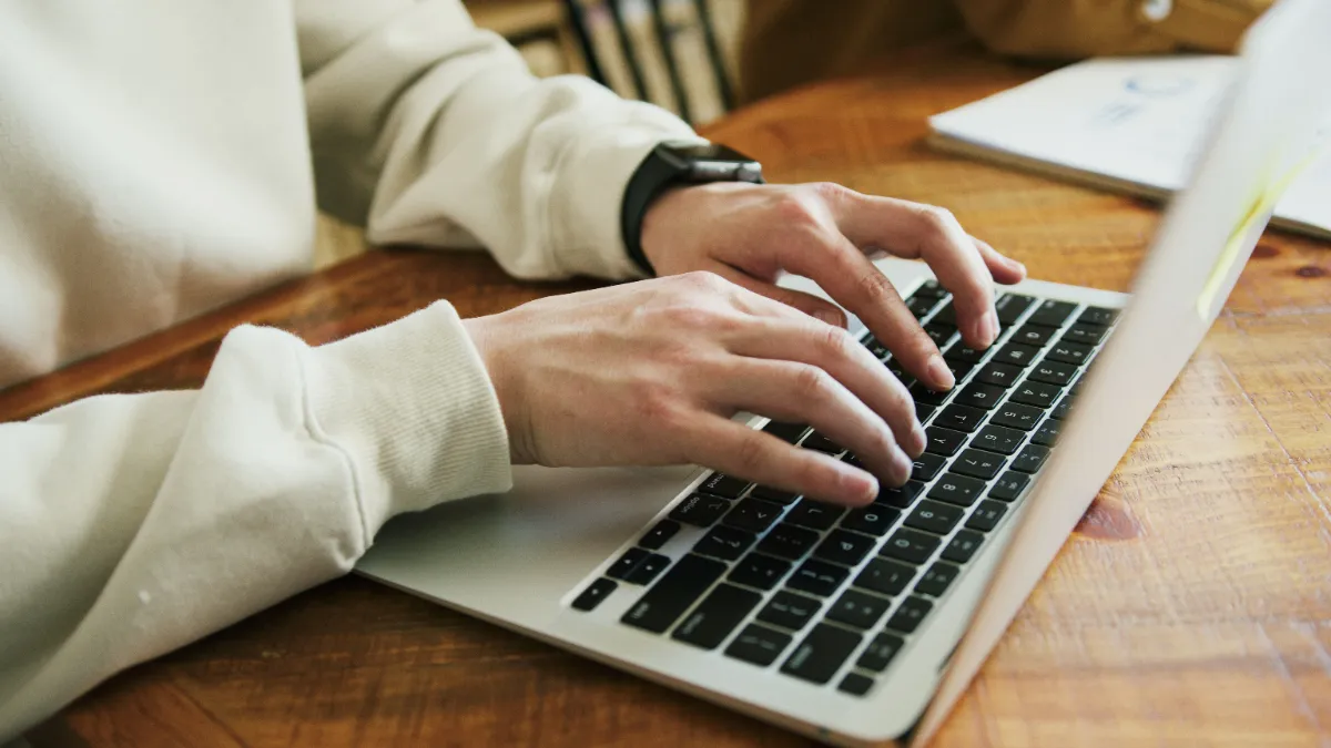 A calm desk setup with a laptop displaying a clean, uncluttered web page